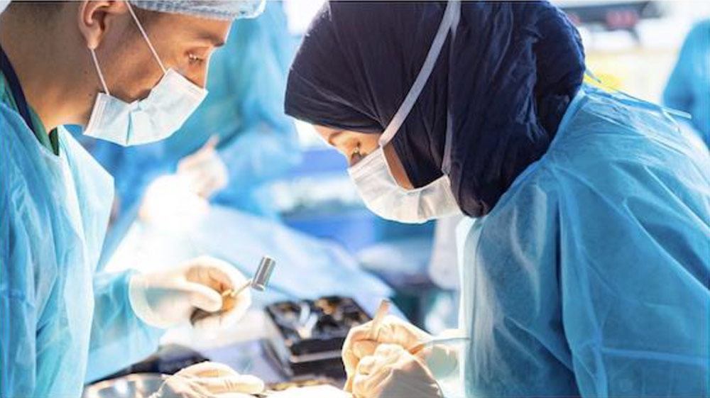 female and male surgeons performing surgery