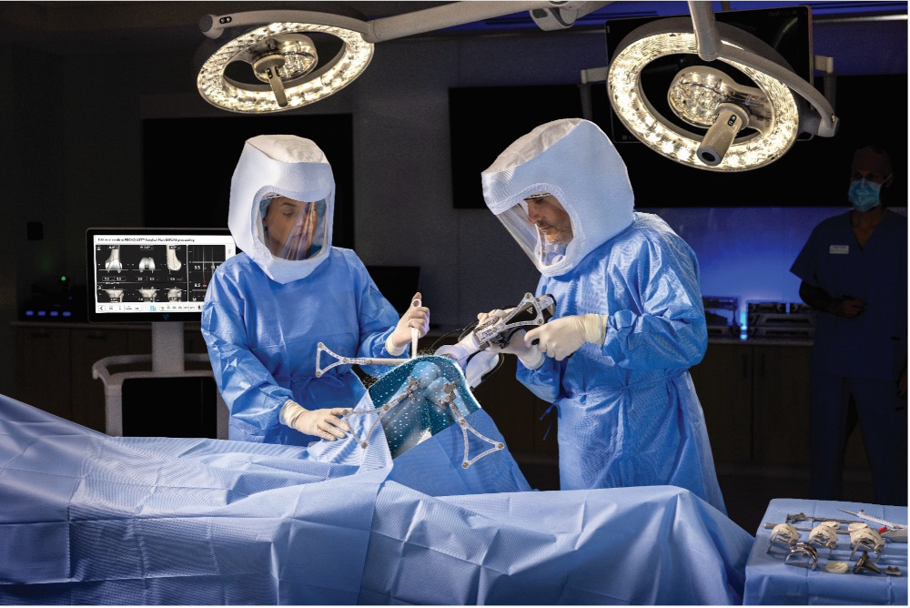 Two surgeons performing knee replacement surgery using VELYS Robotic-Assisted Solution in the OR