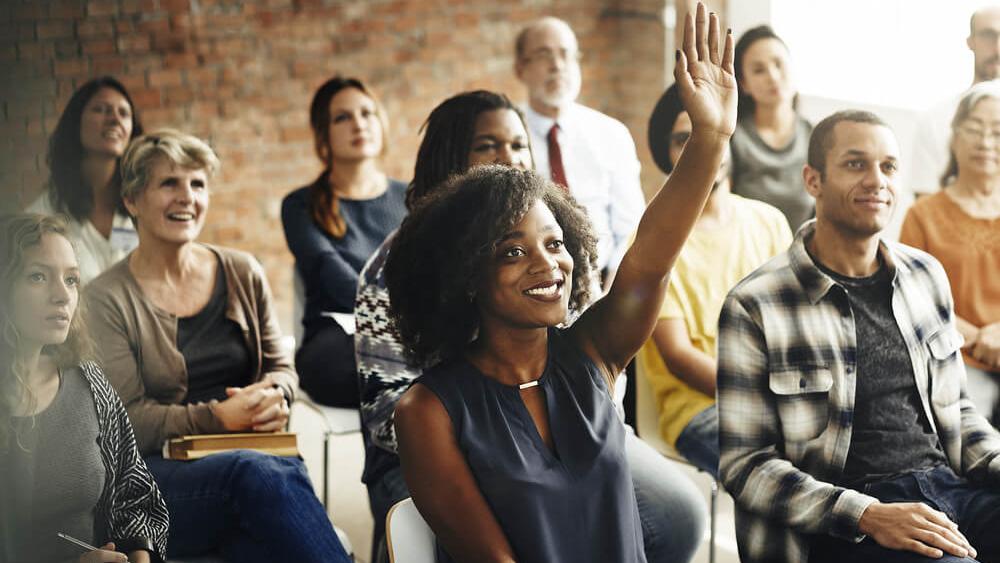 woman raising her hand